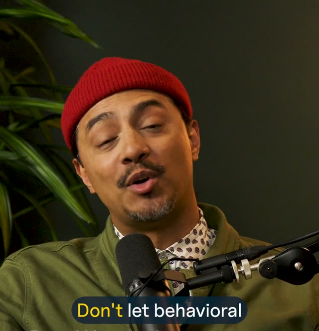 A practitioner mid-sentence on a podcast set
